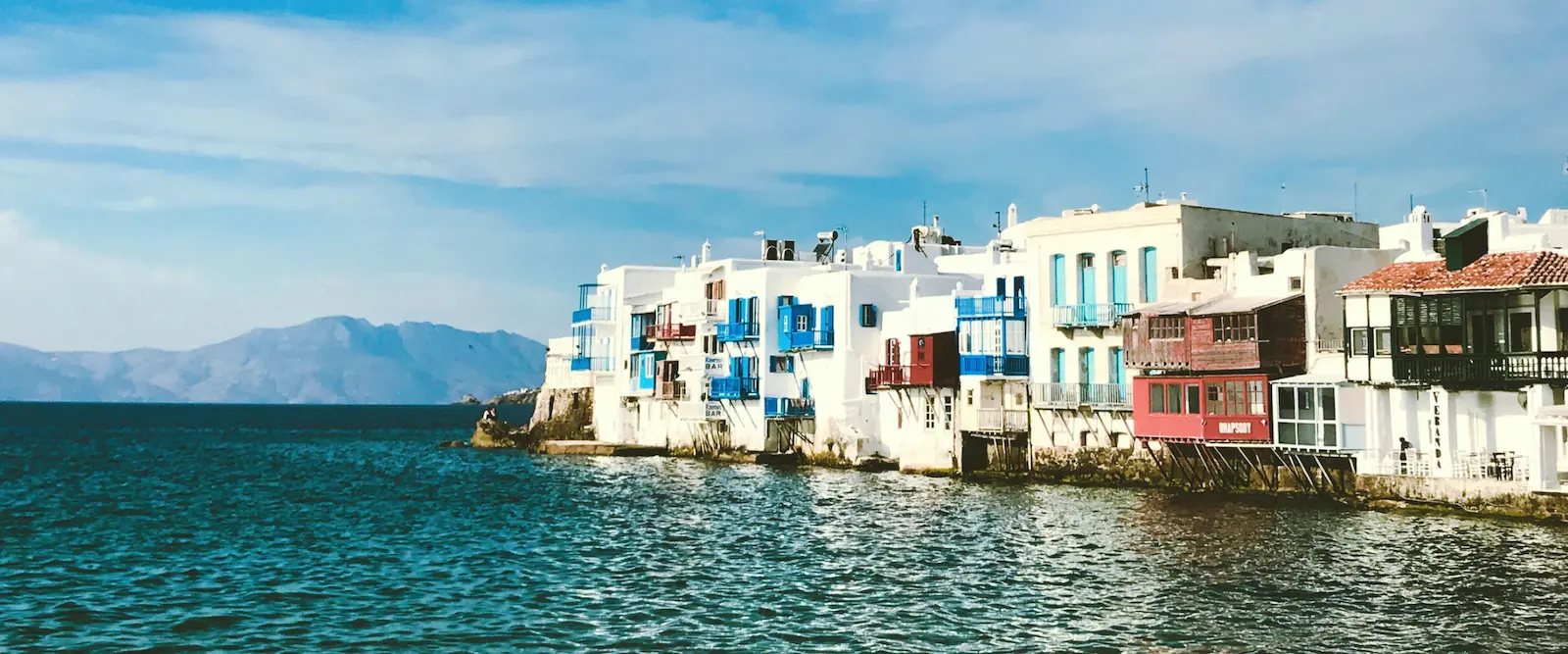 Colorful houses of Little Venice in Mykonos overlooking the Aegean Sea during daytime